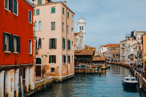 Free Beautiful view of a Venetian canal with colorful buildings in Italy. Stock Photo