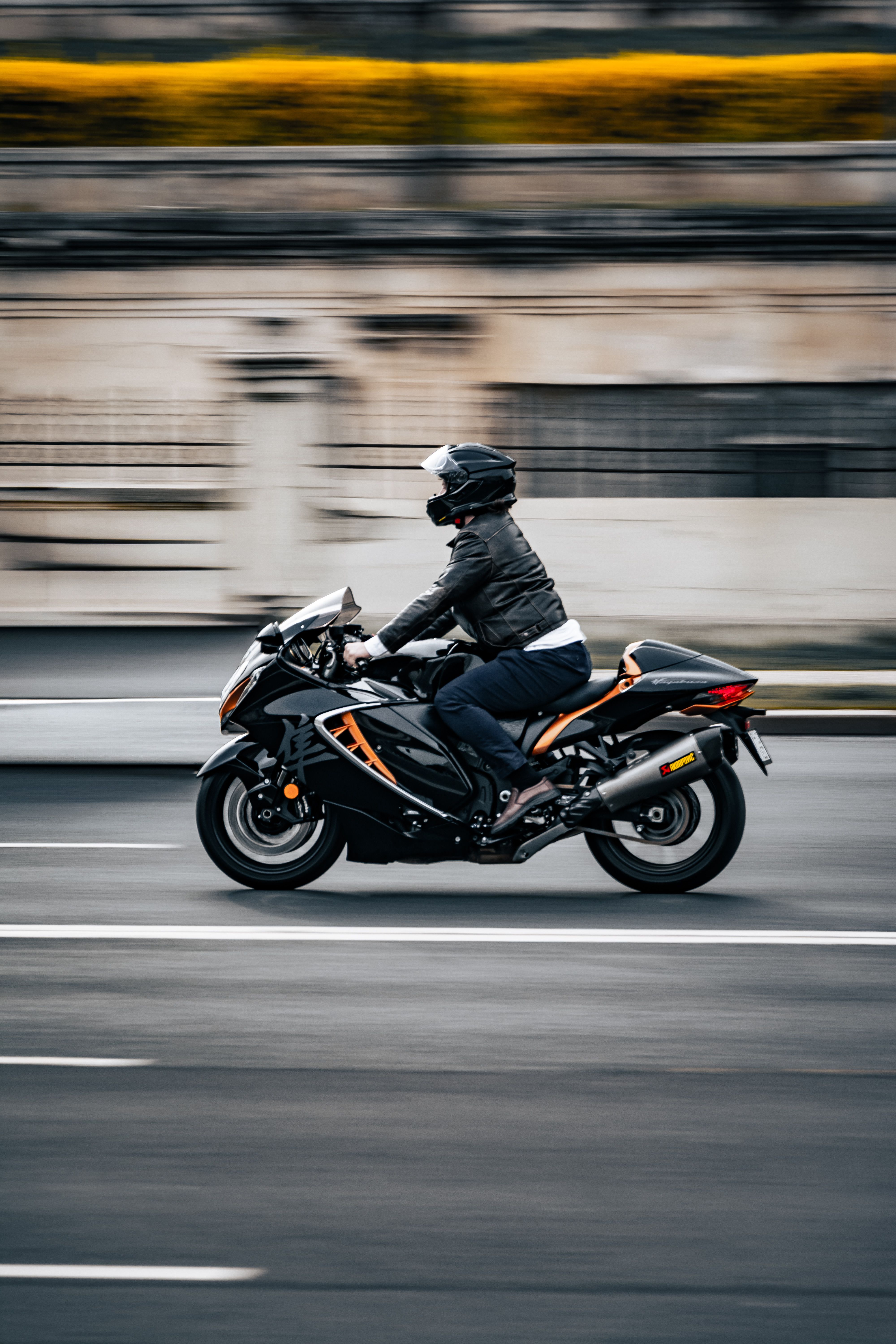Motorcyclist Riding Fast on Urban Road · Free Stock Photo