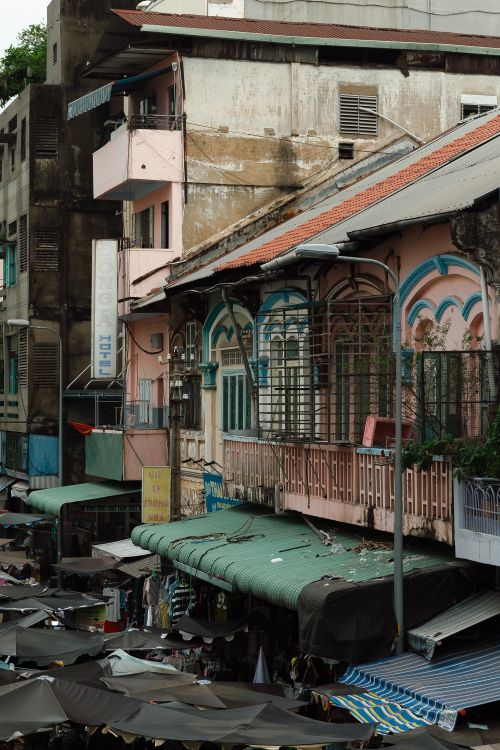 Free Vibrant street view of market stalls and colorful building facade in bustling city area. Stock Photo
