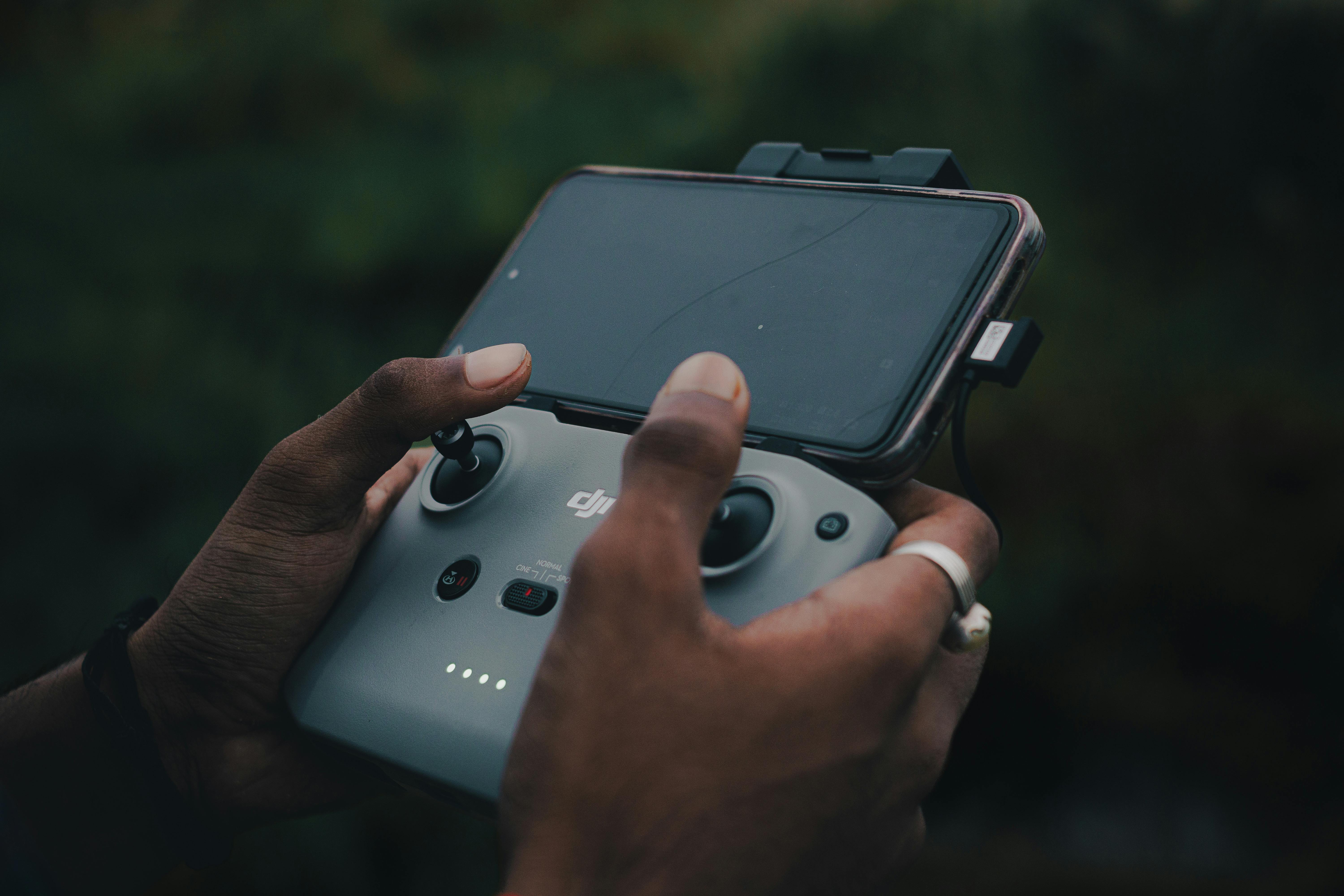 drone pilot with smartphone showing insurance app - Drone liability insurance cost