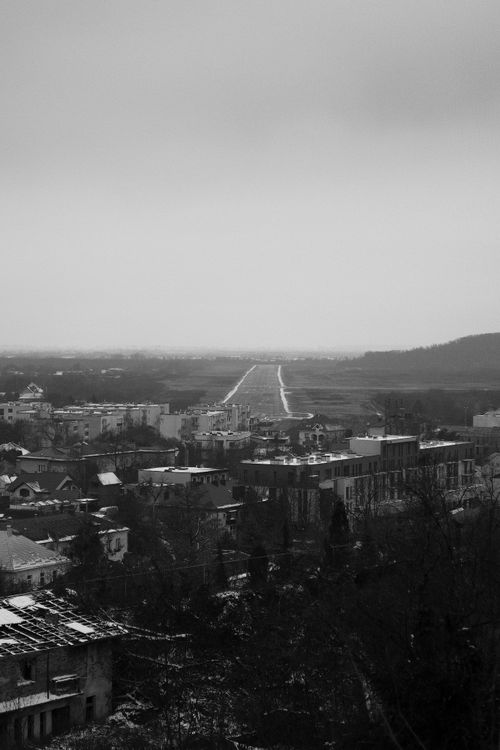 Free Black and white view of cityscape with distant runway and misty atmosphere. Stock Photo