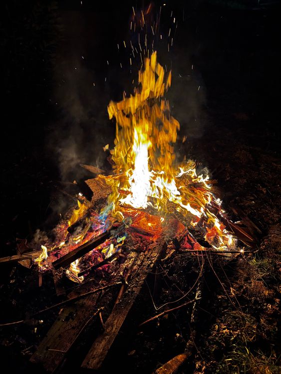 Vibrant Night Bonfire with Sparks in Motion · Free Stock Photo