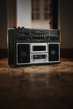 Classic vintage stereo boombox placed on a wooden floor indoors, emphasizing retro audio technology.