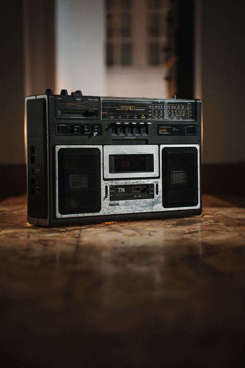 Free Classic vintage stereo boombox placed on a wooden floor indoors, emphasizing retro audio technology. Stock Photo