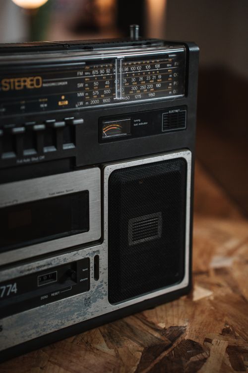 Free A classic cassette player with dials and speaker on a rustic wooden table indoors. Stock Photo