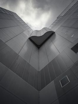 Dramatic low-angle view of a Tokyo skyscraper emphasizing modern architecture.