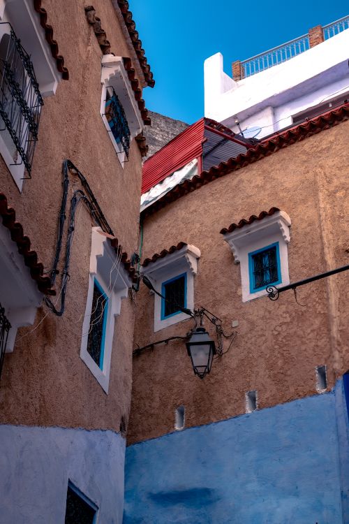 Free Colorful Mediterranean buildings with unique architecture and windows in sunlight. Stock Photo