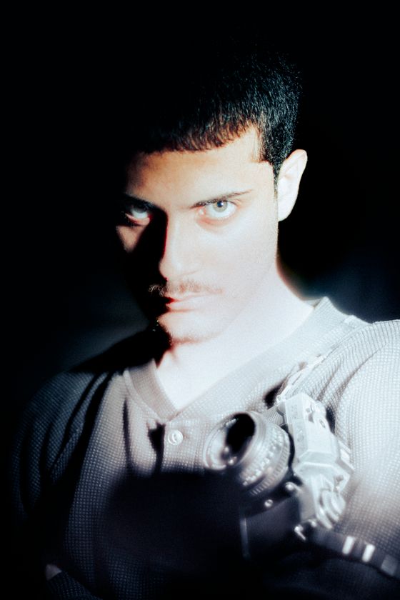 Half-lit portrait with a vintage camera, photo by Vitor Diniz on Pexels