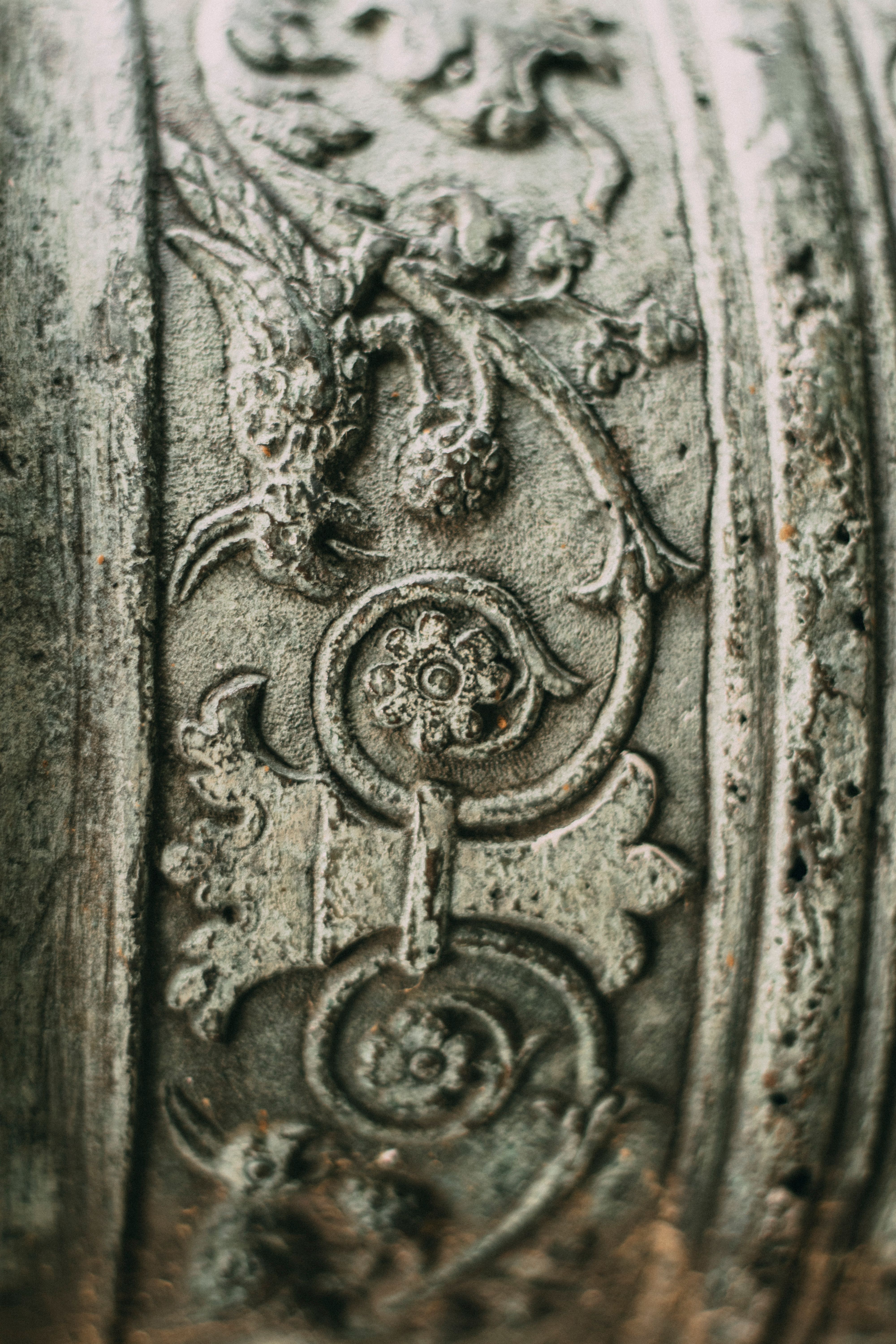 Detailed macro shot of intricate vintage metalwork with floral patterns.