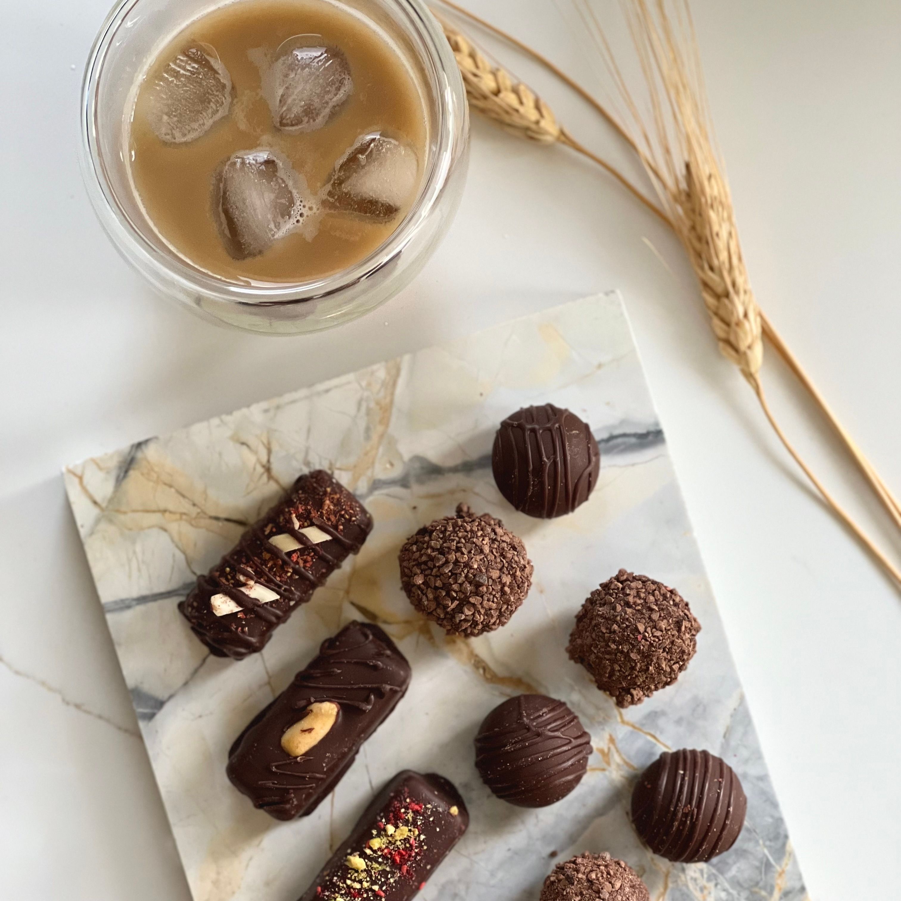 Chocolate truffles and iced coffee on marble — photo by Natalia S on Pexels