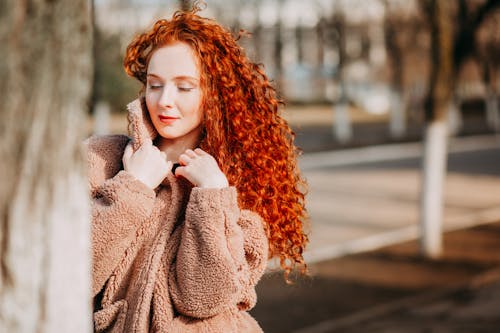 Free Long Curly Red-haired Woman Wearing Brown Fleece Coat Stock Photo