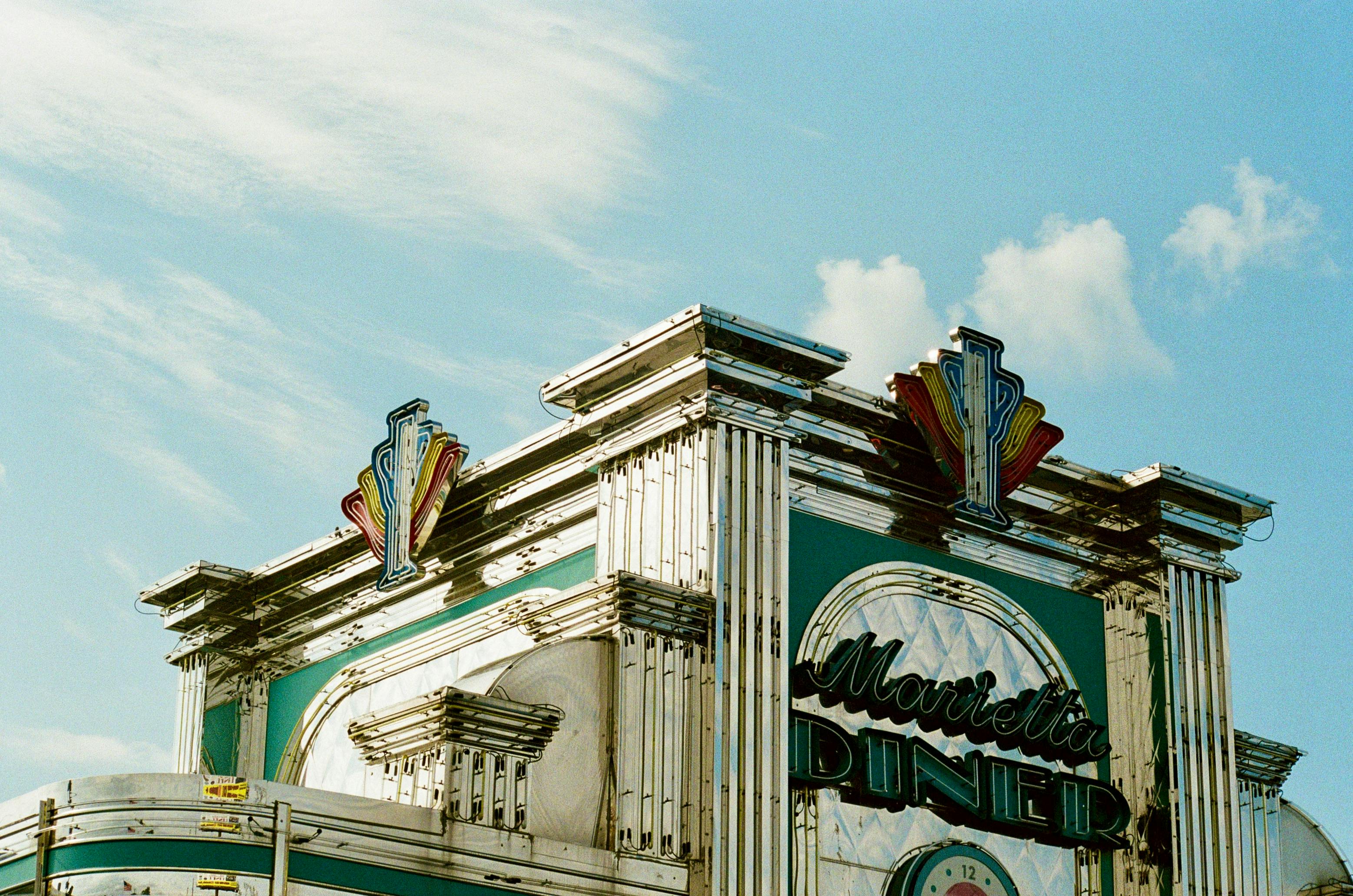 Capture of Marietta Diner's retro exterior under a bright blue sky in Georgia.