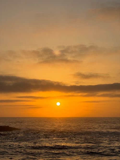 Free Captivating sunset over the ocean at Oualidia, Morocco, with vibrant orange hues. Stock Photo