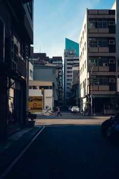 Glimpse of a modern street scene in Taiwan showcasing urban architecture and daily life during daytime.