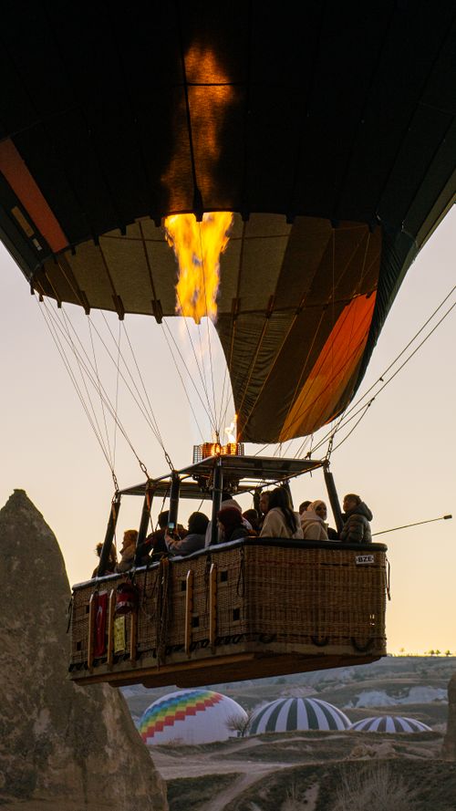 Free A captivating hot air balloon ride above Cappadocia's unique landscapes at sunrise. Stock Photo