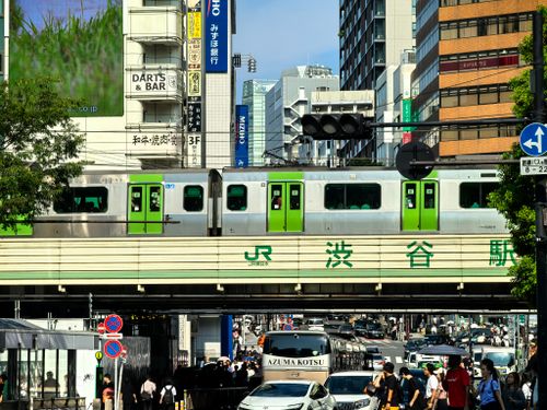 Free Lively city street and train at iconic Shibuya Station, Tokyo. Stock Photo