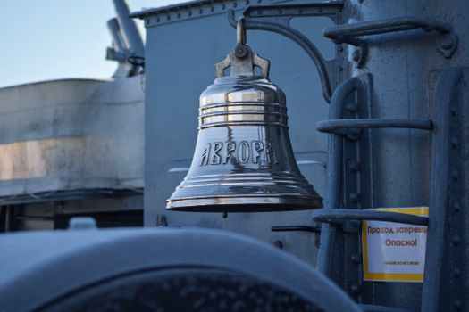 Close-up of the iconic bell on the Russian cruiser Aurora, symbol of historical naval significance.
