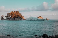 Luxurious Yacht Near Scenic Island in Tranquil Sea