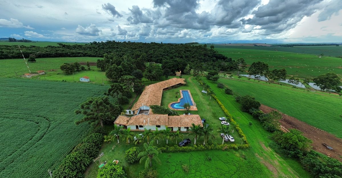 Aerial view of a countryside estate with pool and lush fields in Brazil.