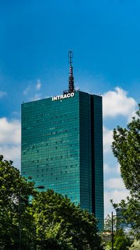 Striking view of the Intraco Building in Warsaw with vibrant sky backdrop.