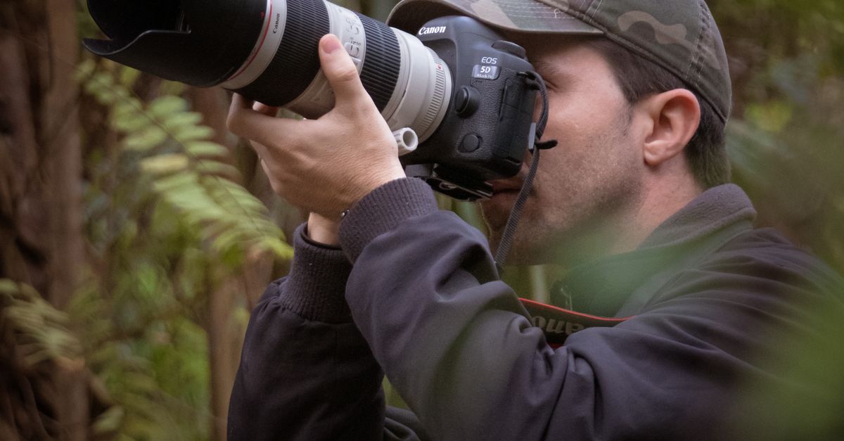 Photographer Capturing Nature with Telephoto Lens · Free Stock Photo