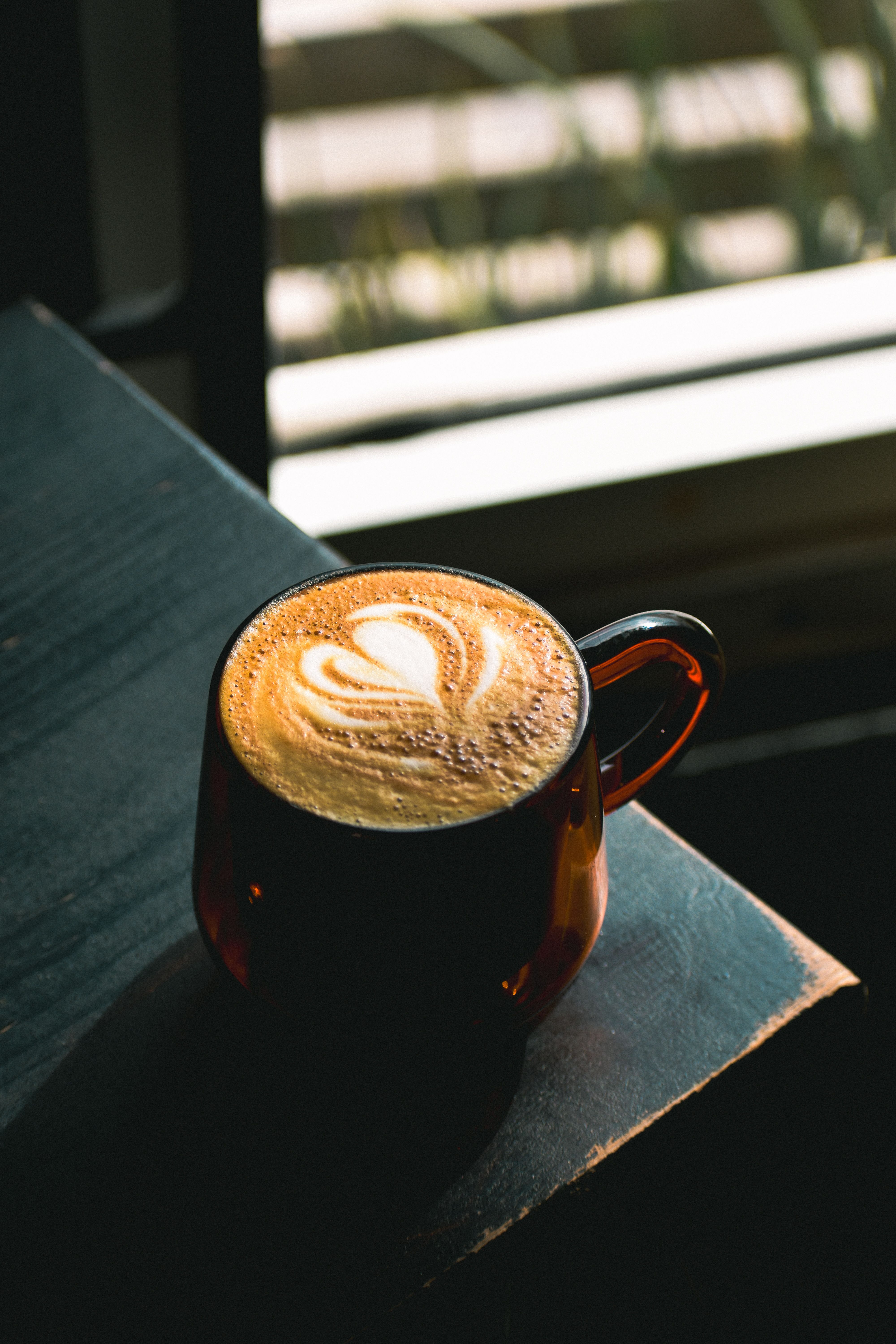 Cozy Café Latte with Latte Art by Window · Free Stock Photo