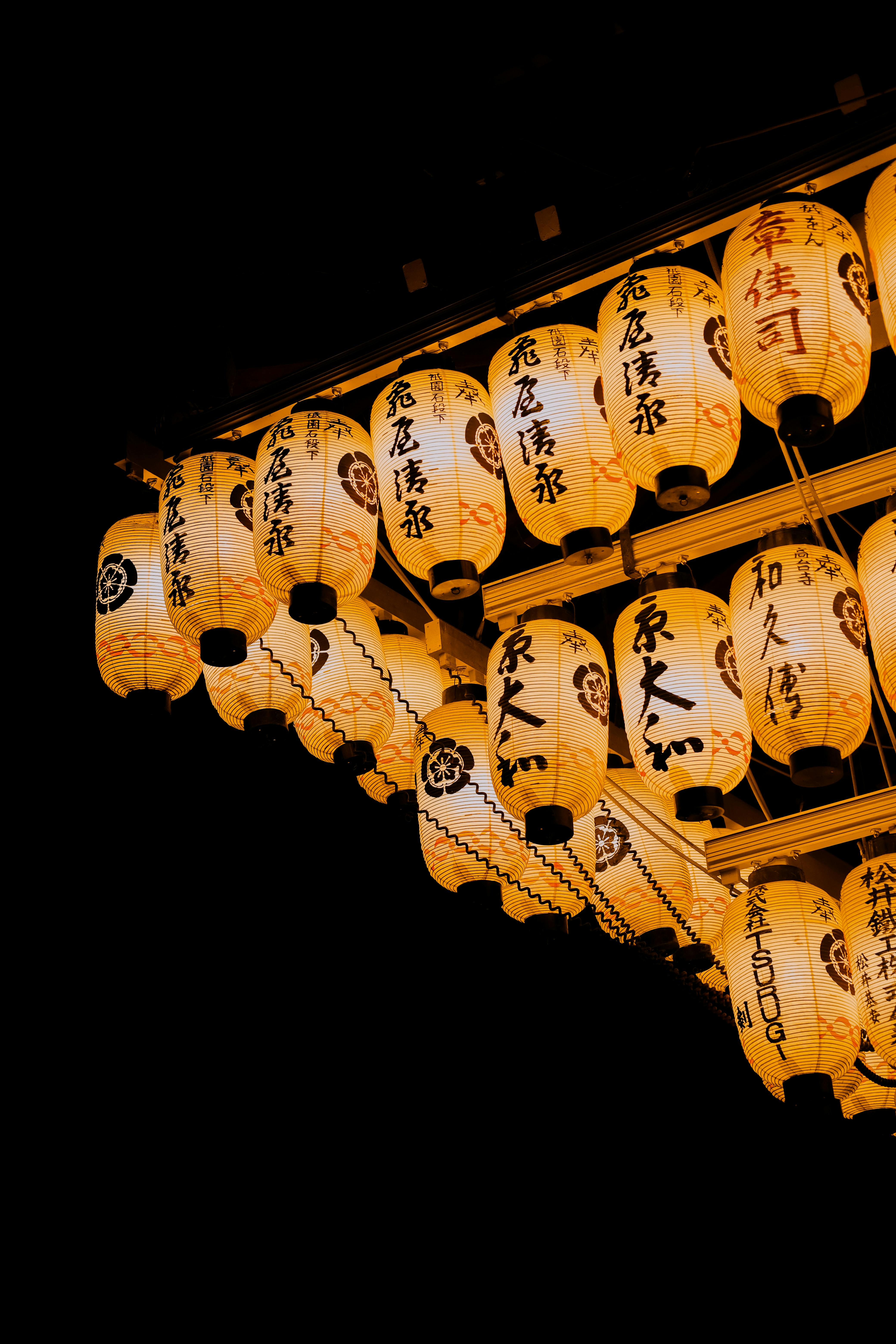 A captivating night shot of illuminated Japanese paper lanterns in Kyoto, showcasing cultural heritage.