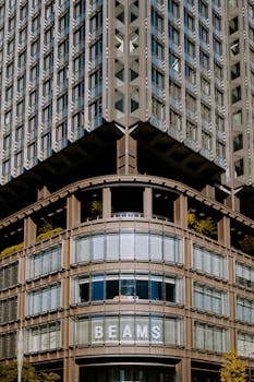 Contemporary high-rise building in Kyoto, Japan featuring geometric patterns and glass facade.