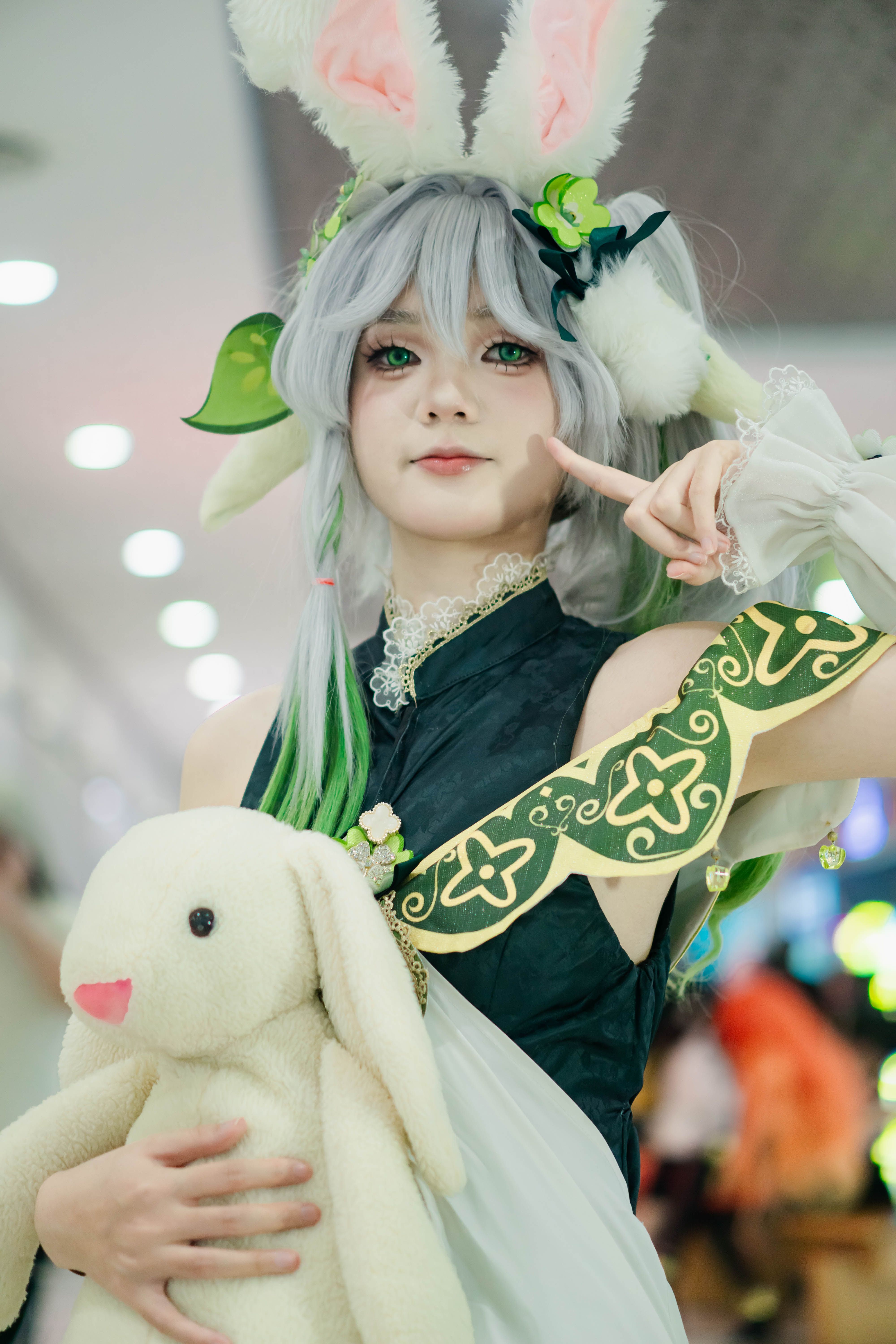 Person in cosplay holding a plush rabbit, adding a playful touch to their creative outfit.