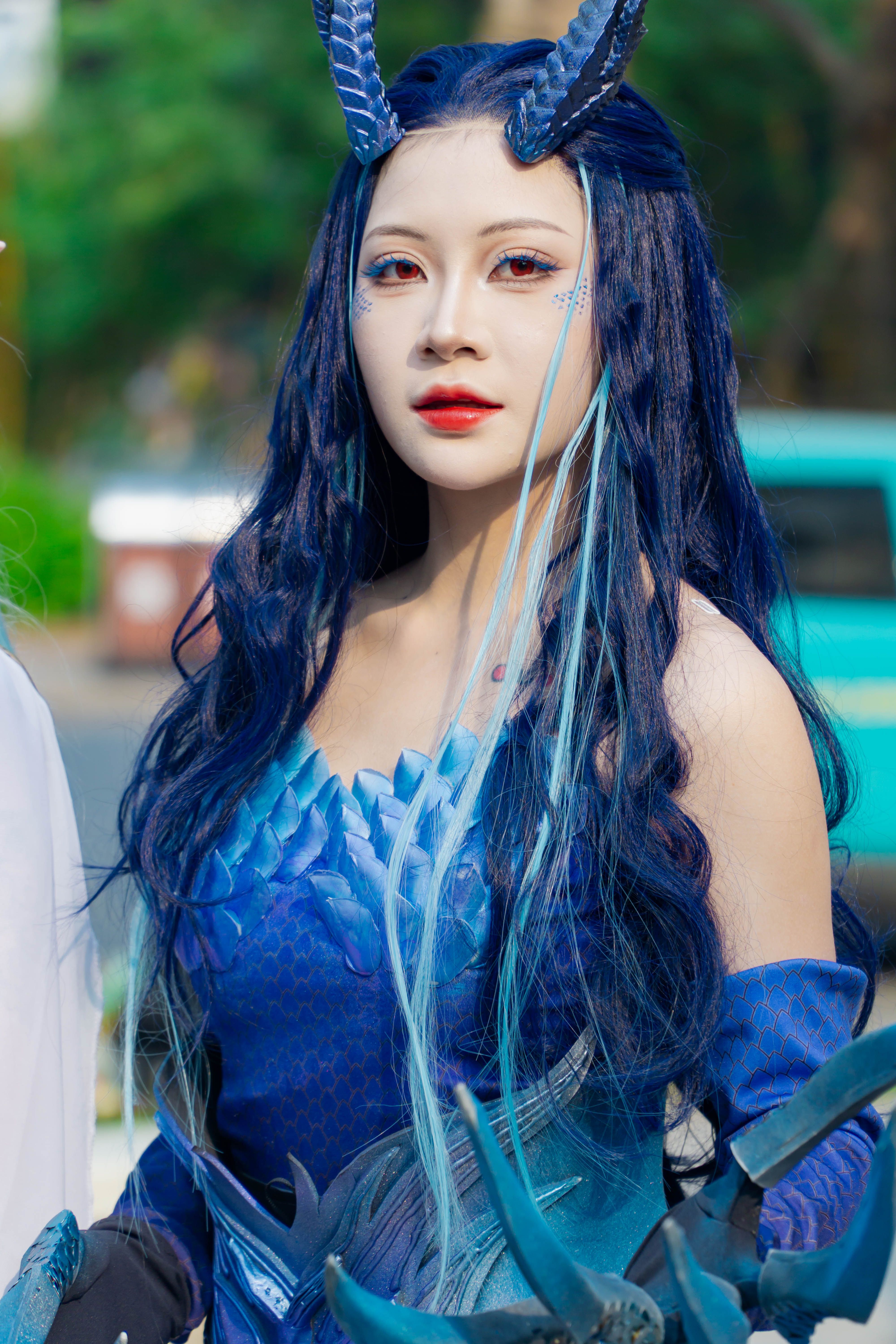Woman in Blue Fantasy Costume with Horns Outdoors