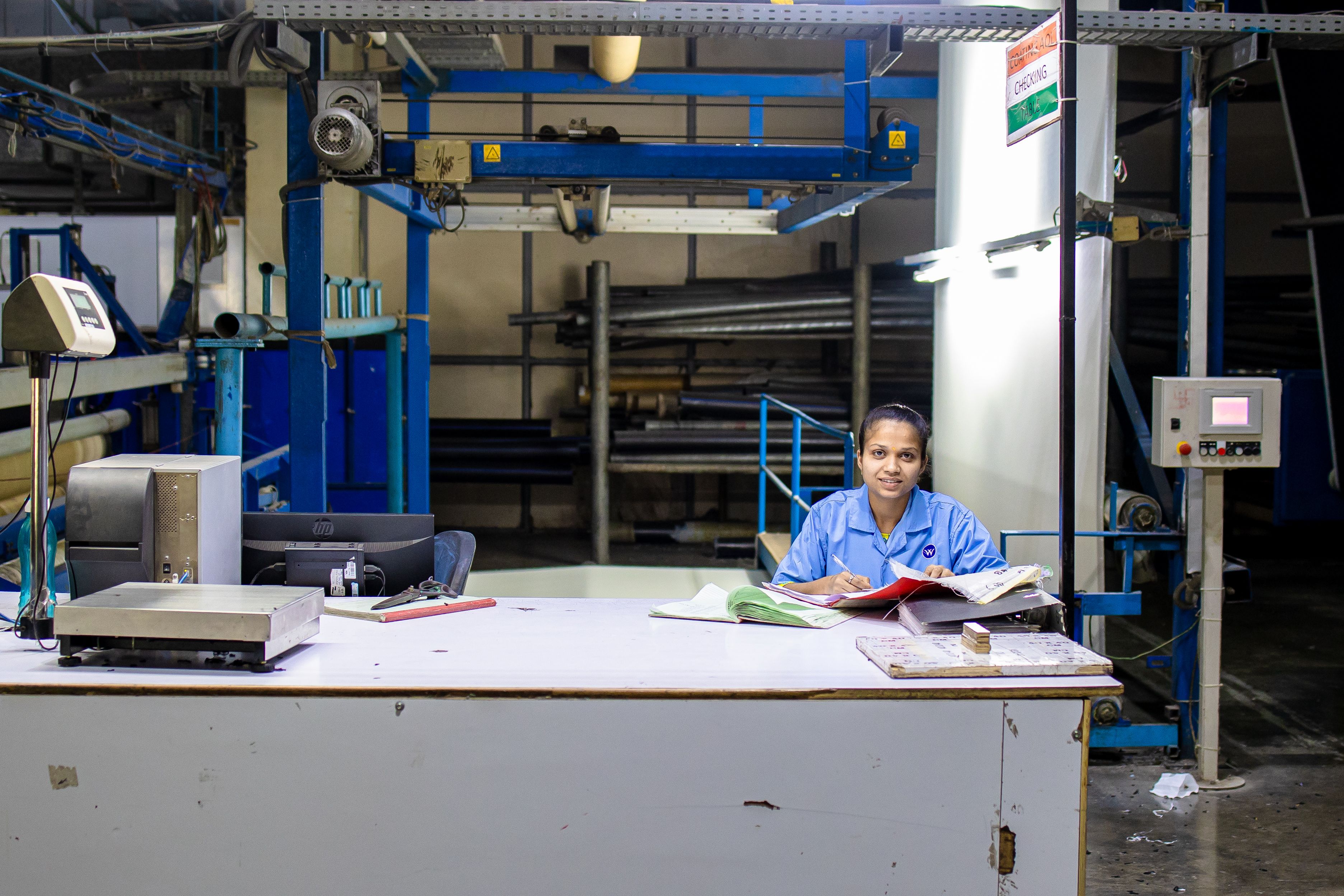 Female Textile Worker at Industrial Factory Desk · Free Stock Photo