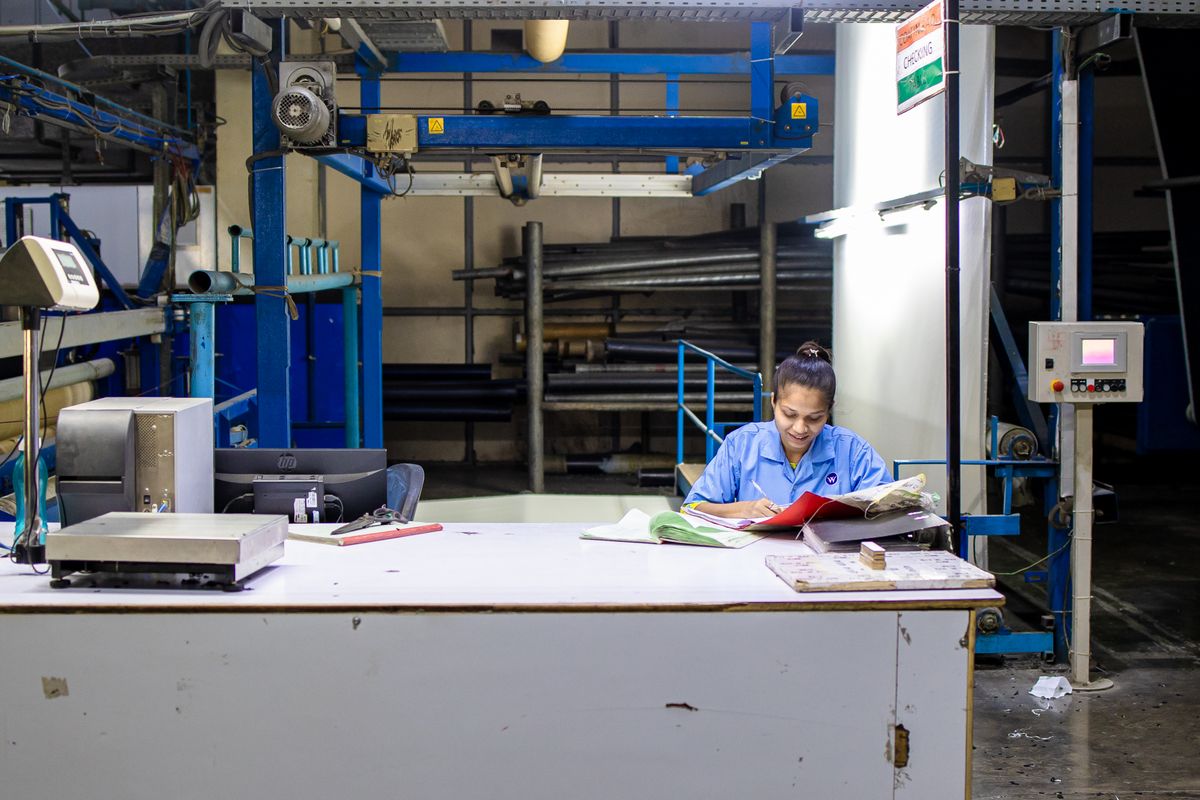 An employee reviews a workplace complaint on a smartphone before submitting it.