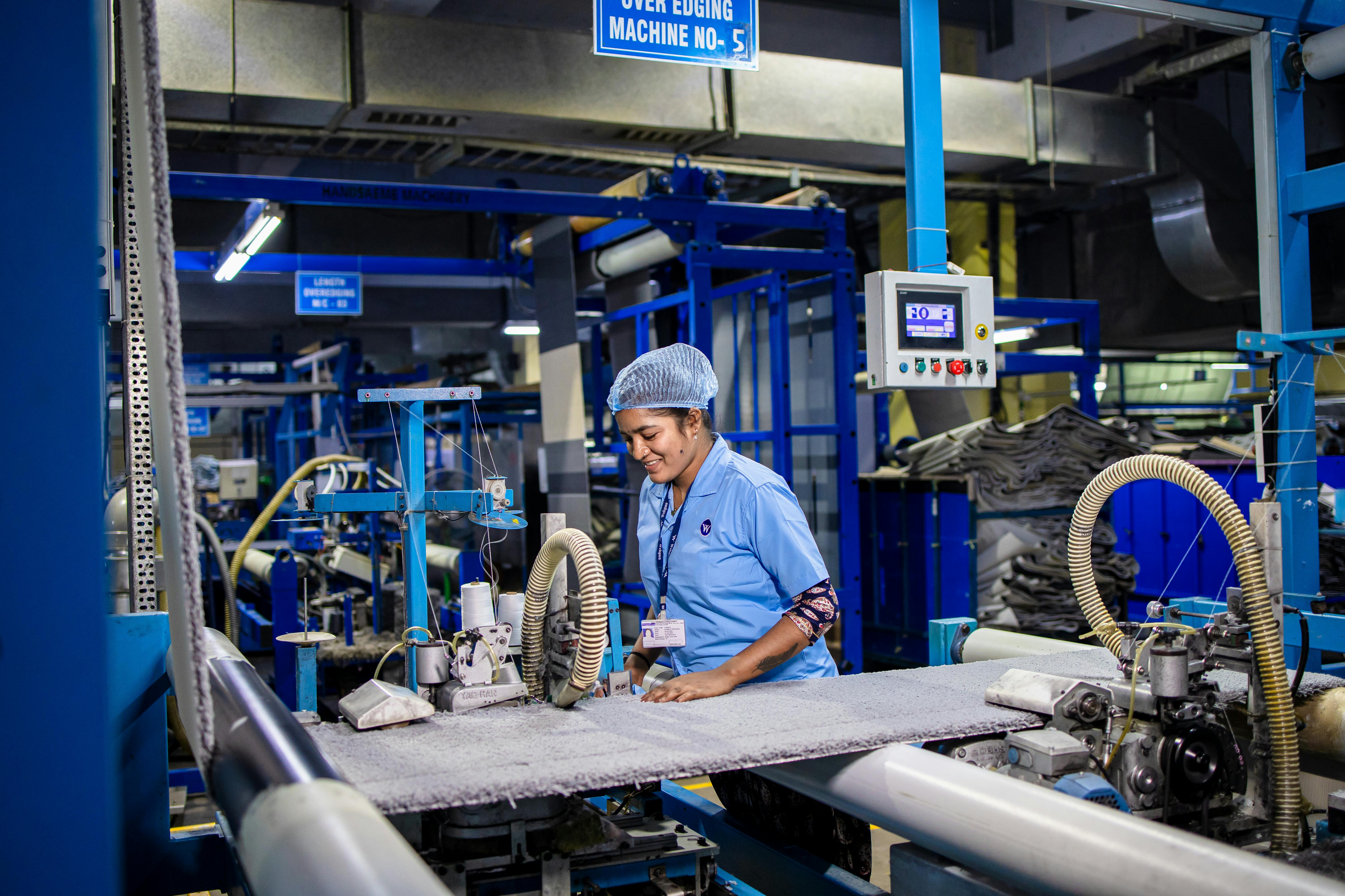 Indian factory workers assembling product standees from wood and metal materials