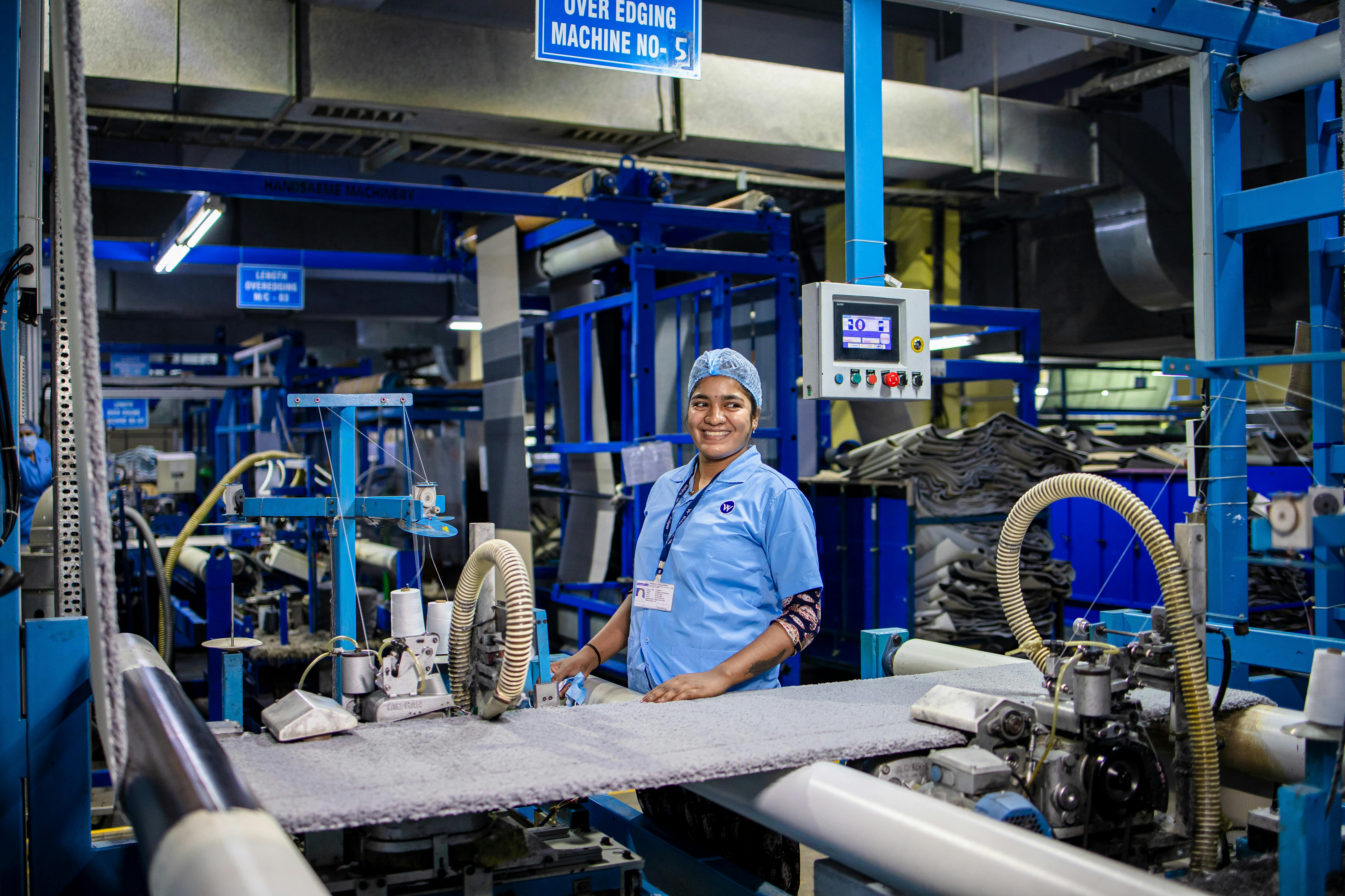 A modern, clean factory interior with automated machinery and workers in a bright, organized environment - global sourcing