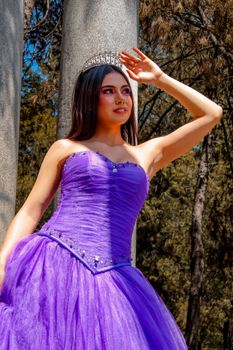 Woman in a purple dress with a tiara enjoys a sunny day outdoors in Mexico City.