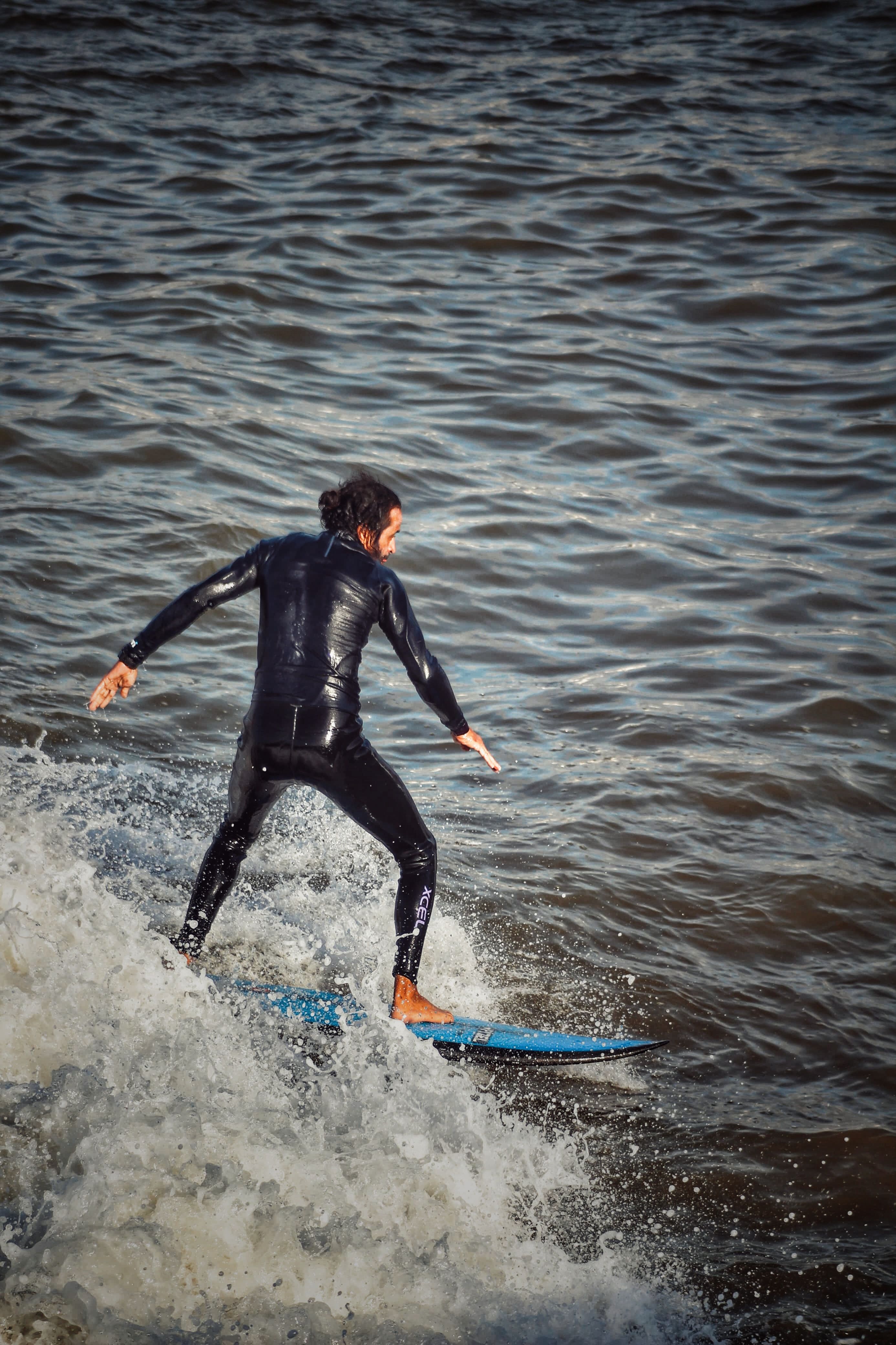 Surfer Riding Waves with Blue Surfboard · Free Stock Photo