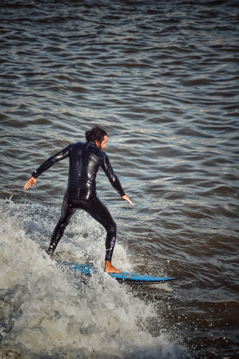 Surfer Riding Waves with Blue Surfboard · Free Stock Photo