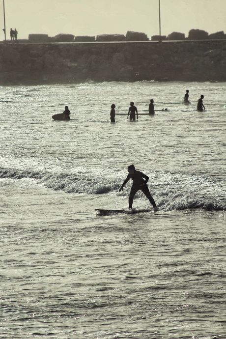 Surfer silhouetted against the horizon — photo by yassir draka on Pexels