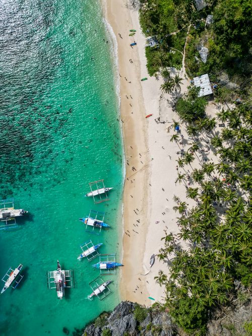 Free Stunning aerial shot showcasing a white sandy beach and turquoise waters in the Philippines. Stock Photo