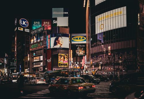 Free Vibrant night scene in Shibuya, Tokyo, showcasing illuminated billboards and busy streets. Stock Photo
