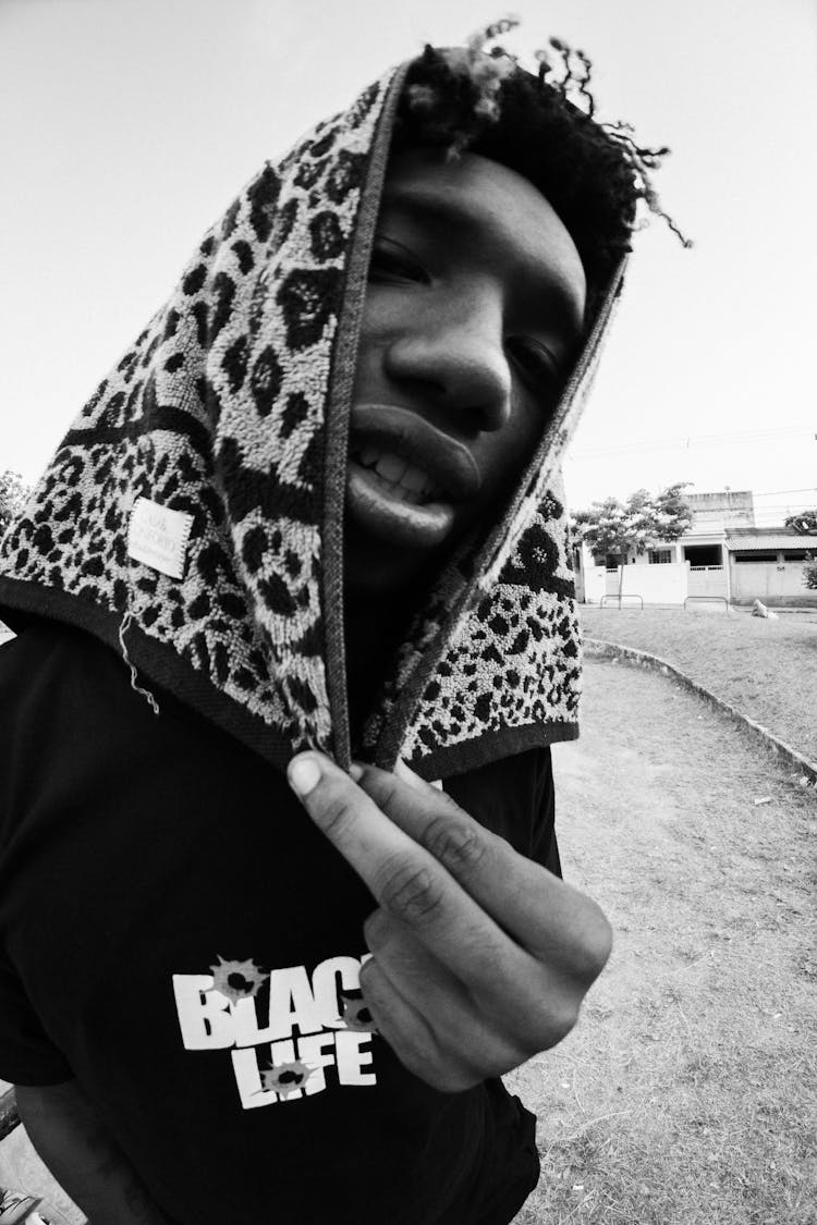 Grayscale Photo Of Man Covering Head With Animal Print Towel