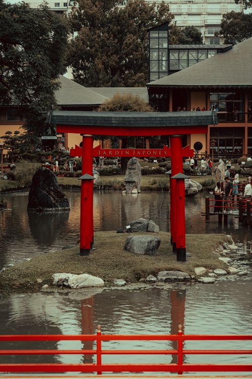 Free Stunning Japanese garden with a red Torii gate and serene pond capturing timeless beauty. Stock Photo