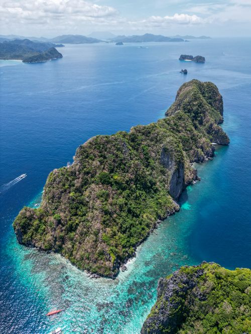 Free Stunning aerial view of lush islands surrounded by blue waters in Palawan, Philippines, perfect for travel inspiration. Stock Photo