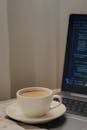 Cozy Workspace with Coffee and Coding Laptop