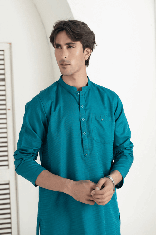 Free Portrait of a man in a traditional blue kurta indoors, showcasing ethnic fashion. Stock Photo