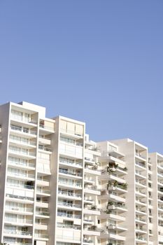 High-rise apartment buildings under a blue sky in Santa Marta, Colombia.