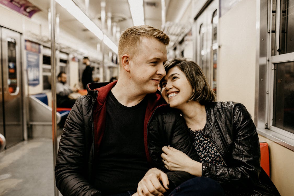 Man and Woman Sitting Inside a Train