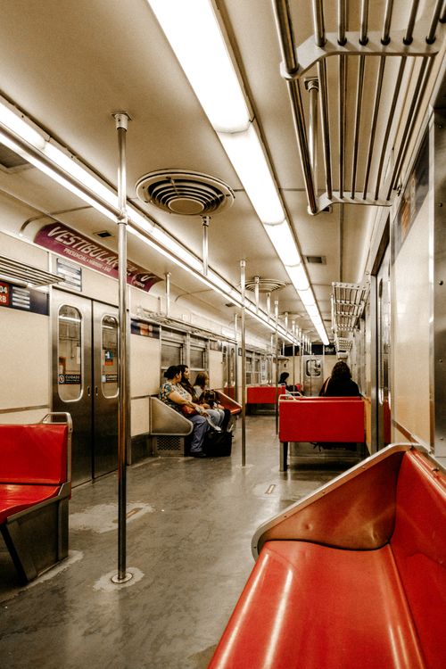Free Spacious subway train interior with passengers seated, capturing a typical urban public transportation scene. Stock Photo