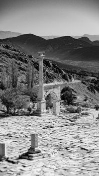 Dramatic black and white shot of ancient ruins and mountains in Turkey.