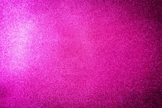 Vibrant pink glitter background with shimmering texture, ideal for festive designs.